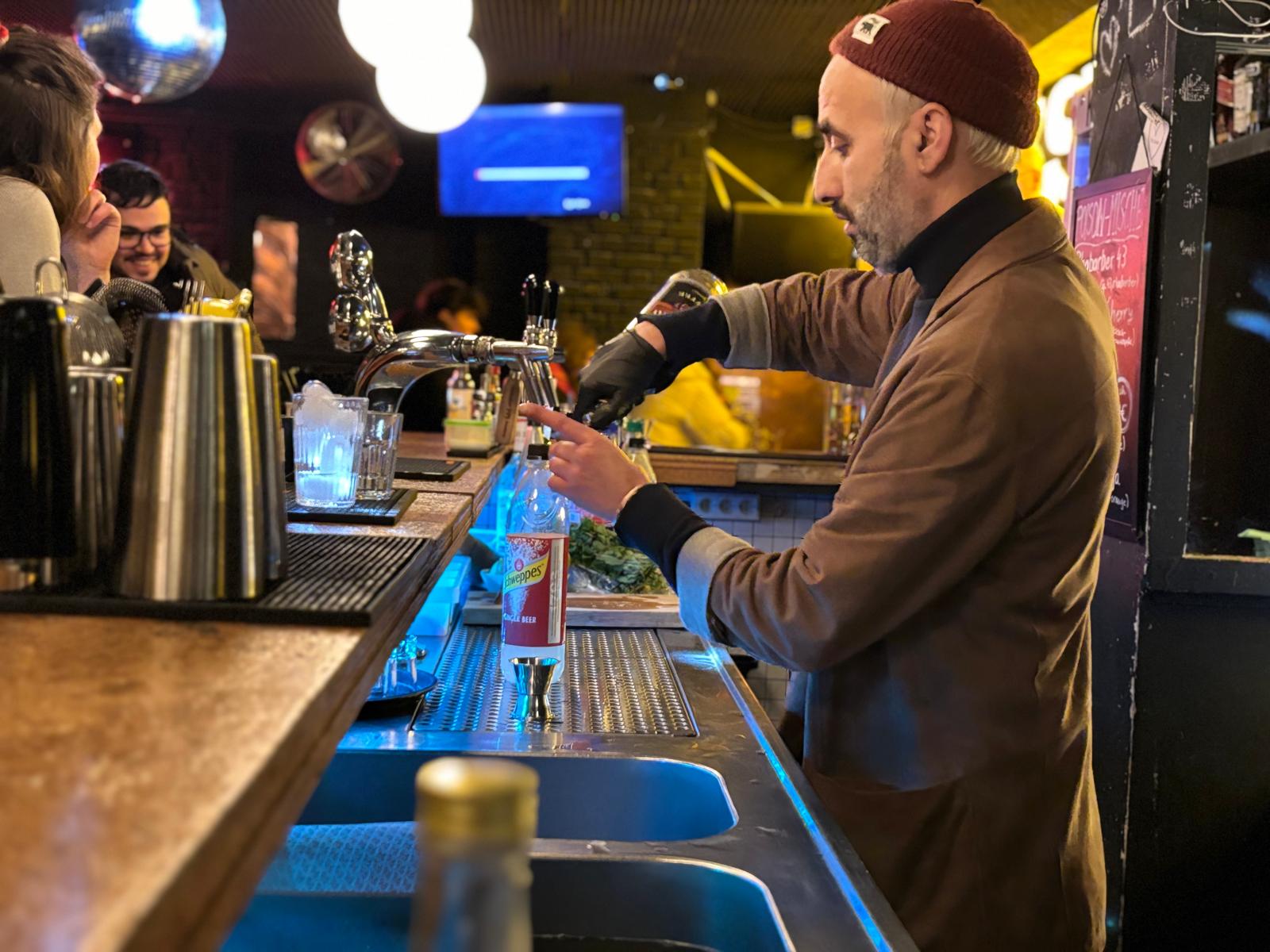 Guests mixing cocktails at the bar